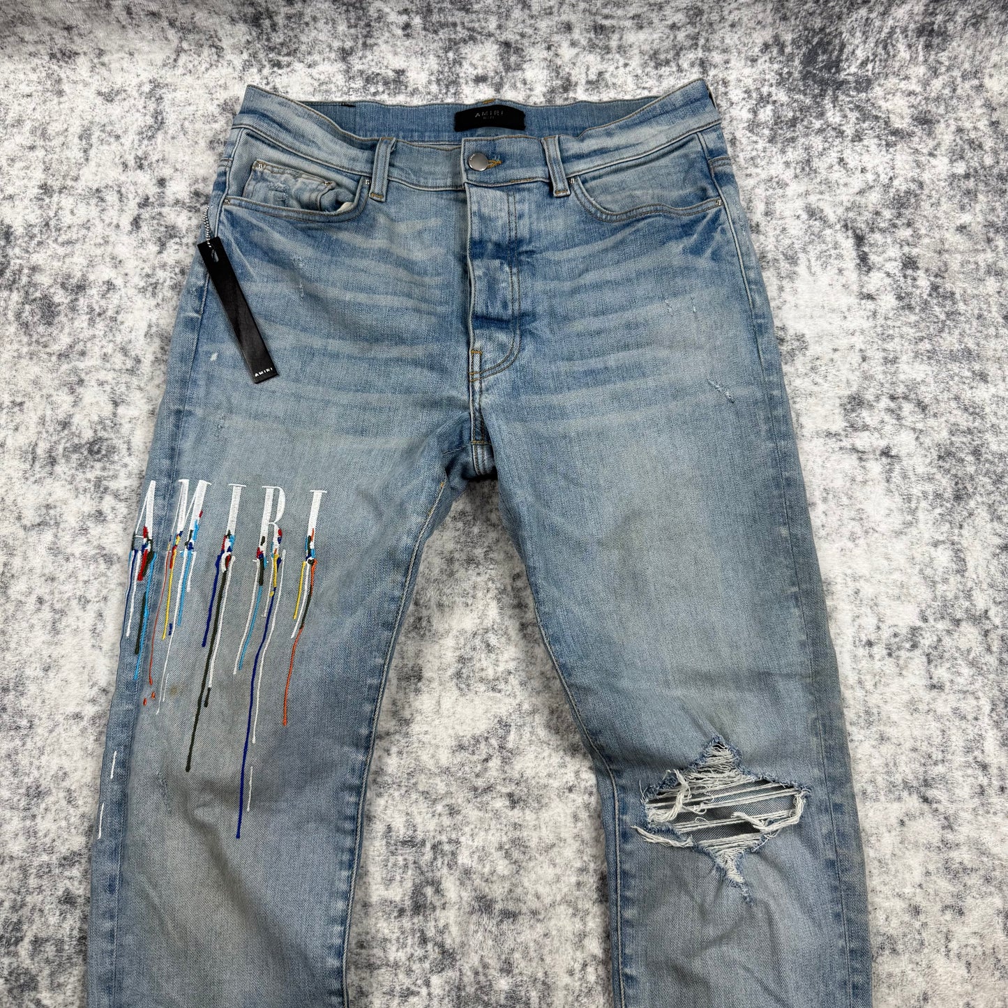 AMIRI Paint Drip Logo Skinny Jeans Light Indigo