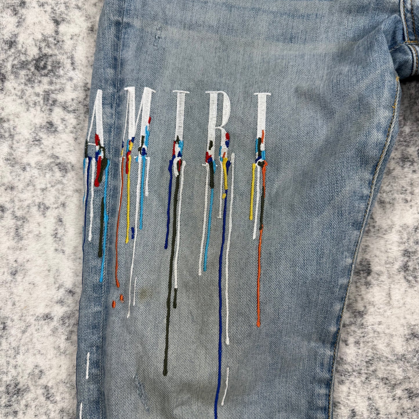 AMIRI Paint Drip Logo Skinny Jeans Light Indigo
