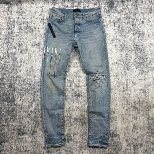 AMIRI Paint Drip Logo Skinny Jeans Light Indigo