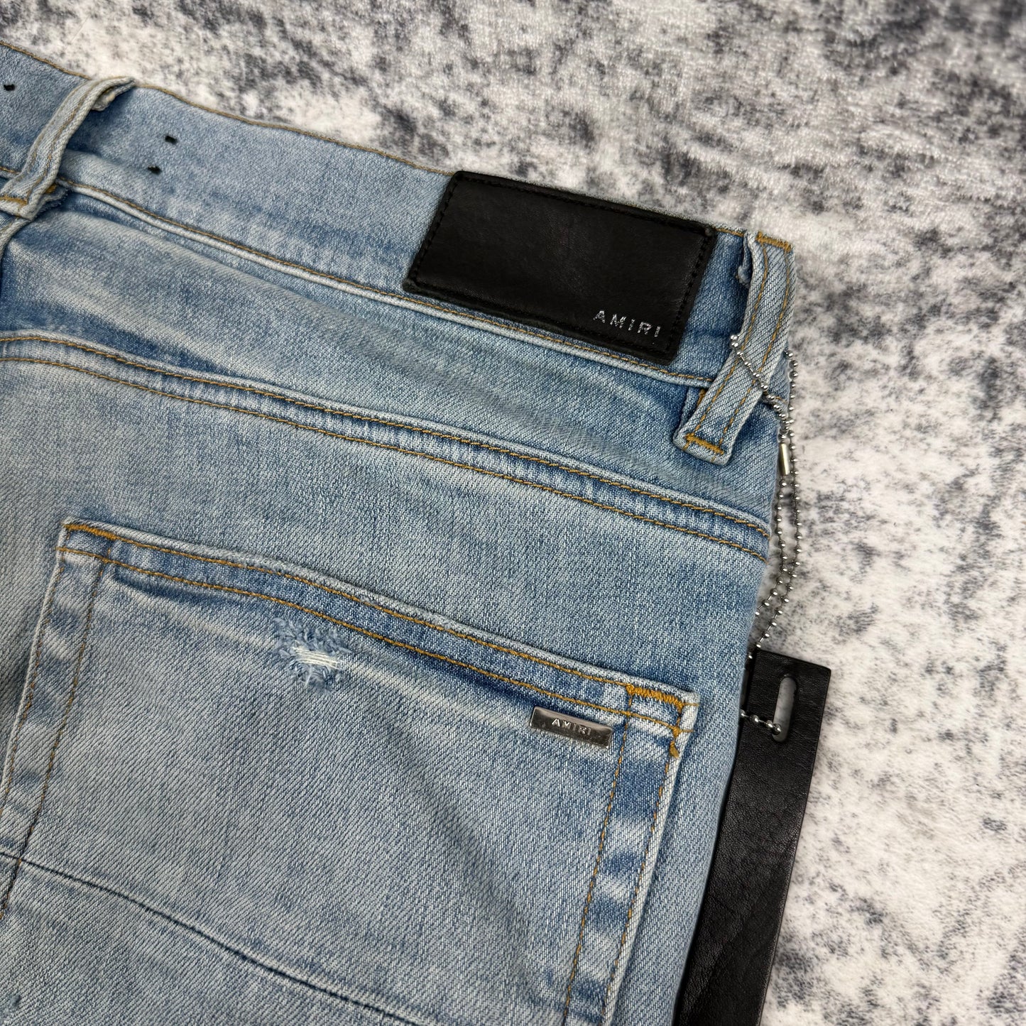 AMIRI Paint Drip Logo Skinny Jeans Light Indigo